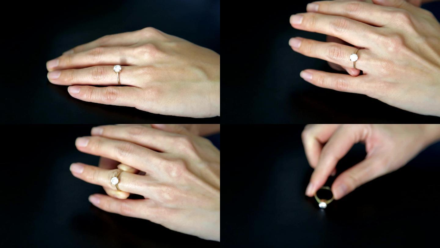 从无名指上取下订婚戒指。