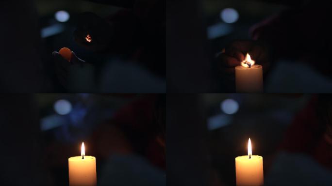 夜晚在黑暗中用火柴点燃蜡烛