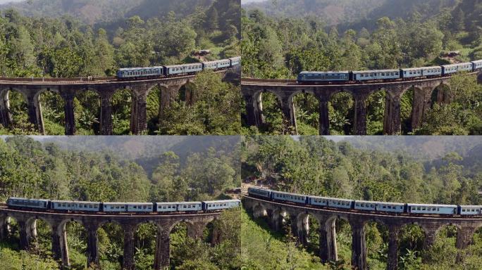 蓝色火车经过旧九拱桥的无人机镜头
