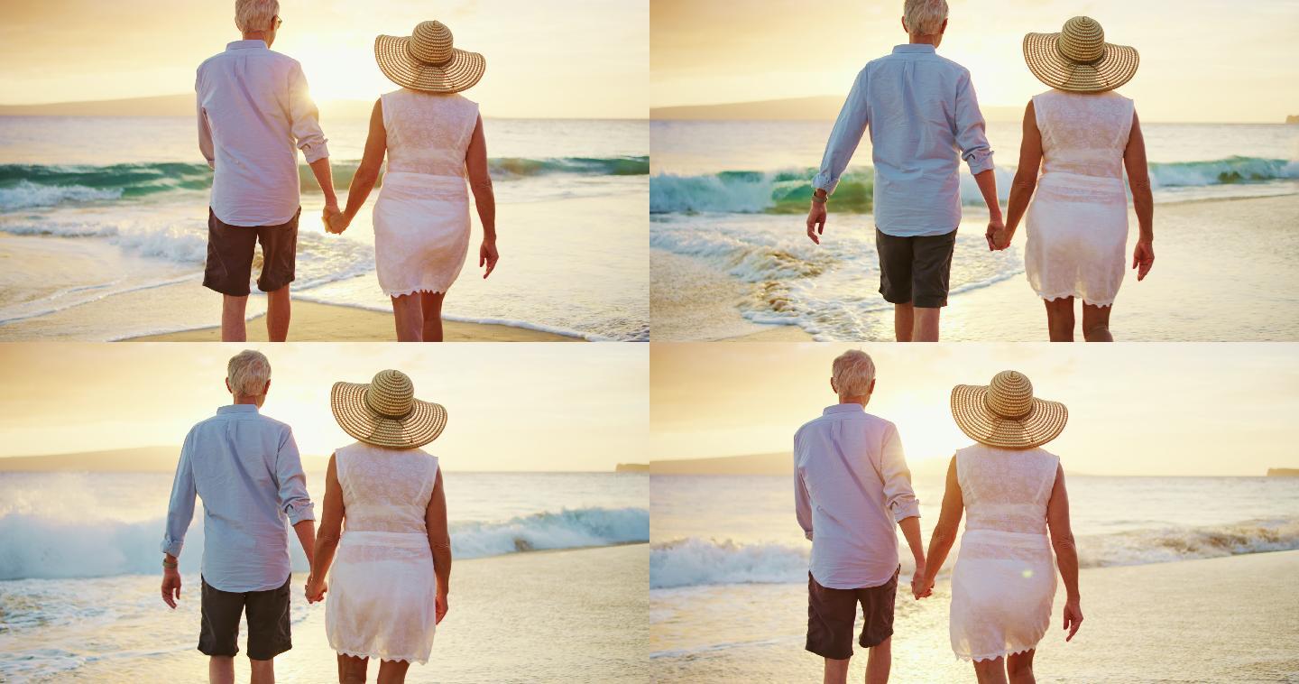 快乐的退休夫妇在海滩上享受漫步