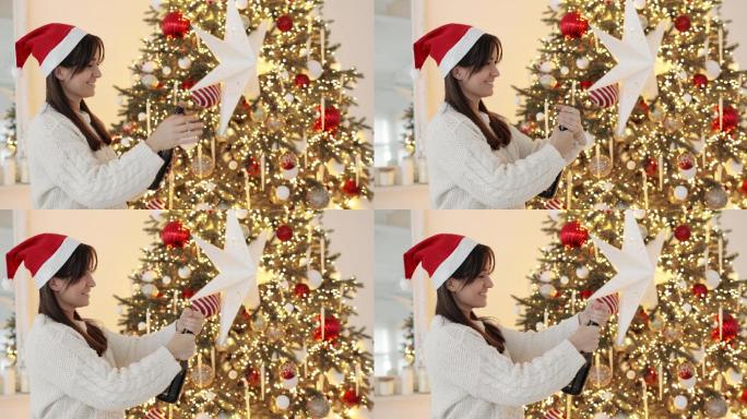 戴着圣诞帽的女人正在圣诞树旁打开香槟