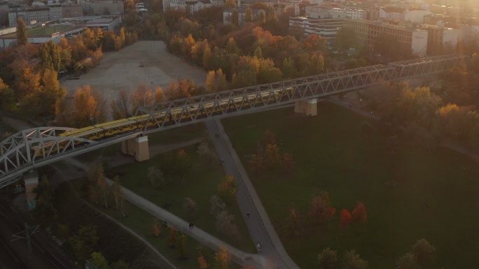 地铁列车在公共公园上方的桥上通过