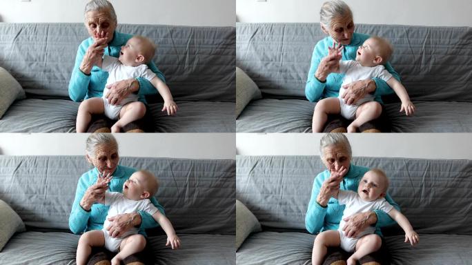 一位老奶奶坐在沙发上，怀里抱着一个小孙子