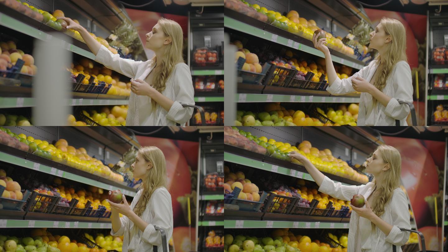 年轻女子在杂货店挑选成熟的芒果