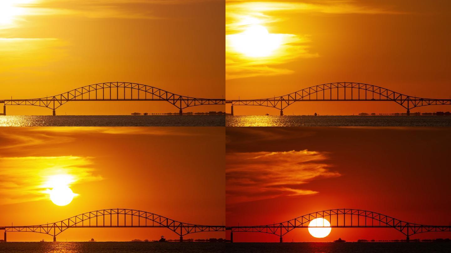 太阳落在一座钢制系杆拱桥后面