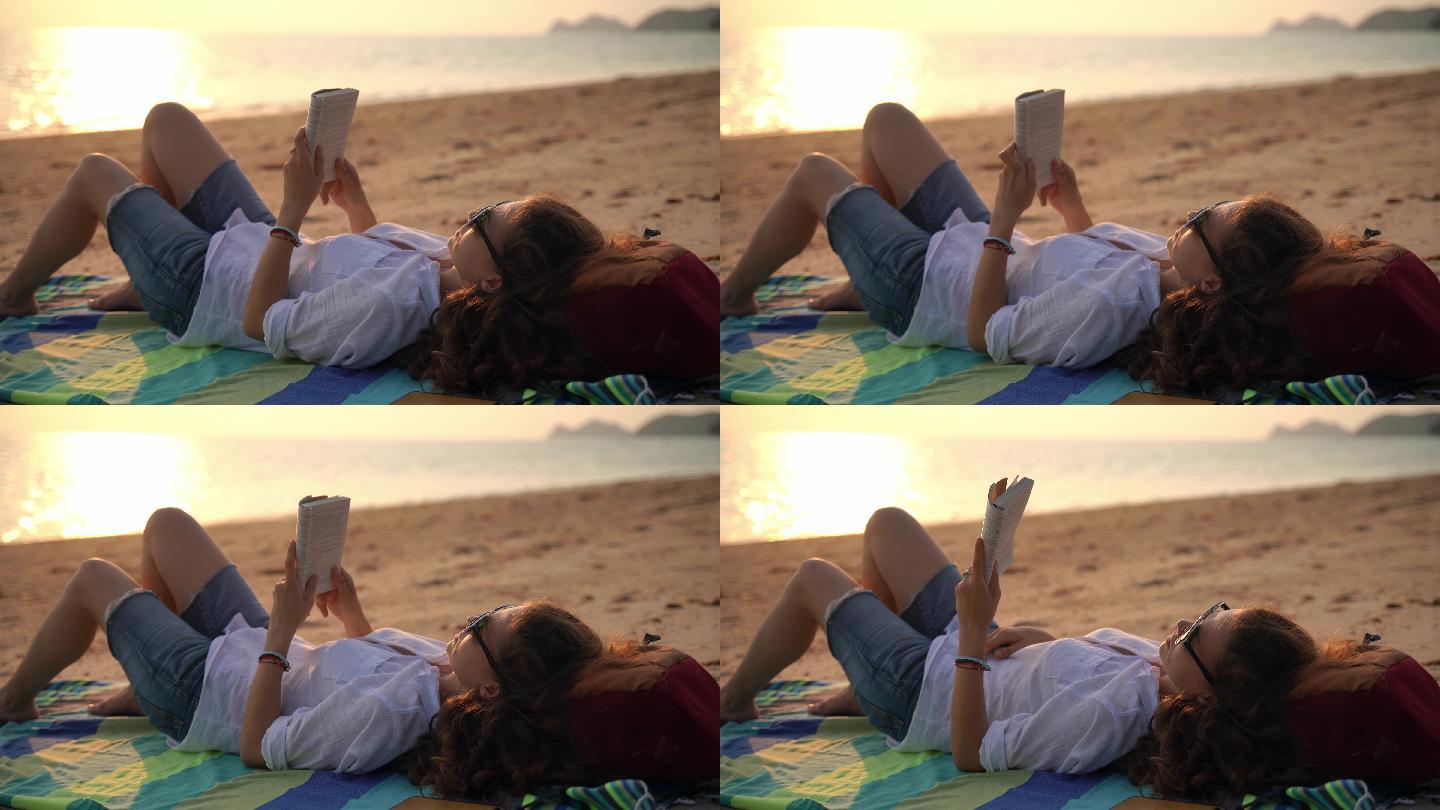 一位年轻女子正在海滩上看书