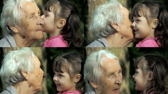 孙女亲吻祖母。祖孙三代人拥抱