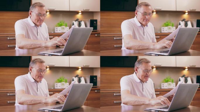 快乐的老人用笔记本电脑