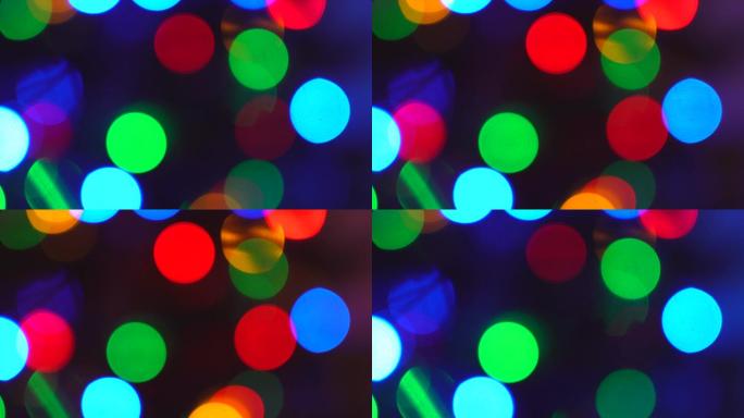 闪烁的抽象彩色圆圈散焦了圣诞灯的背景。