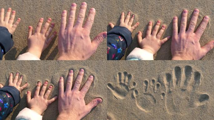 日落时，成人和儿童的手在沙滩上留下手印