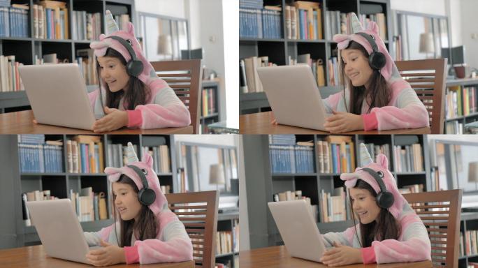 穿着连帽睡衣的小女孩在电脑上视频聊天