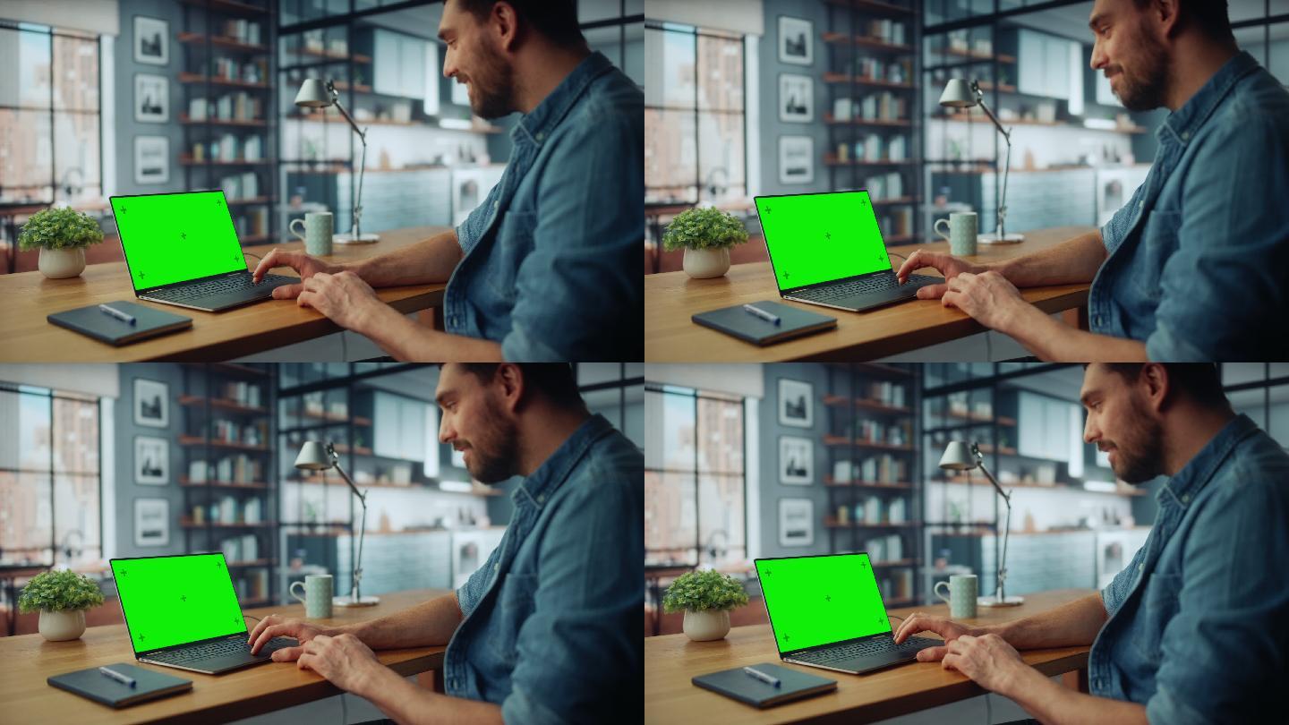 男子在客厅里用带绿色屏幕的笔记本电脑