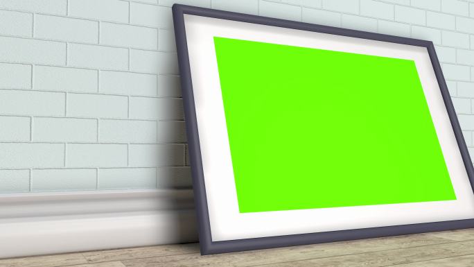 在砖墙背景上有绿色屏幕的画框