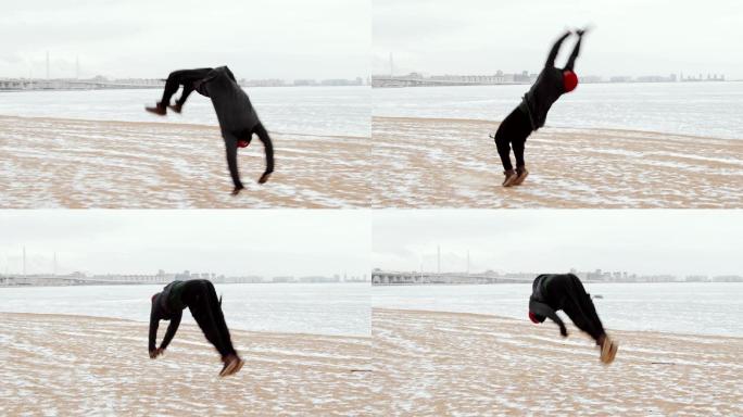 男子跑酷运动员在冰冻的湖岸上做后空翻