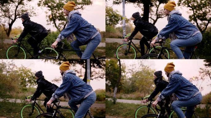 年轻的夫妇骑着自行车在公园里
