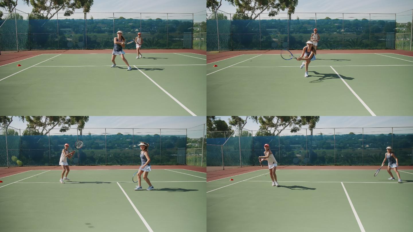 努力打网球的女孩在球场上练习