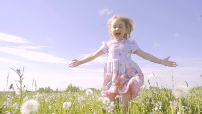 可爱的小女孩在草地上奔跑