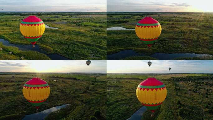 日落时热气球在乡村飞行