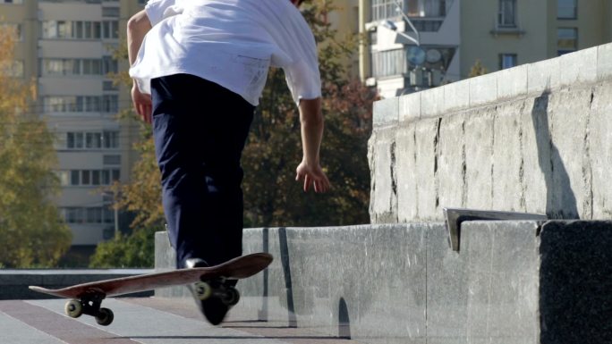 运动员在城市花岗岩壁架上玩滑板