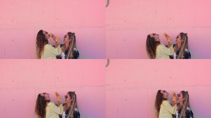 女人在粉红色的墙上舔冰淇淋