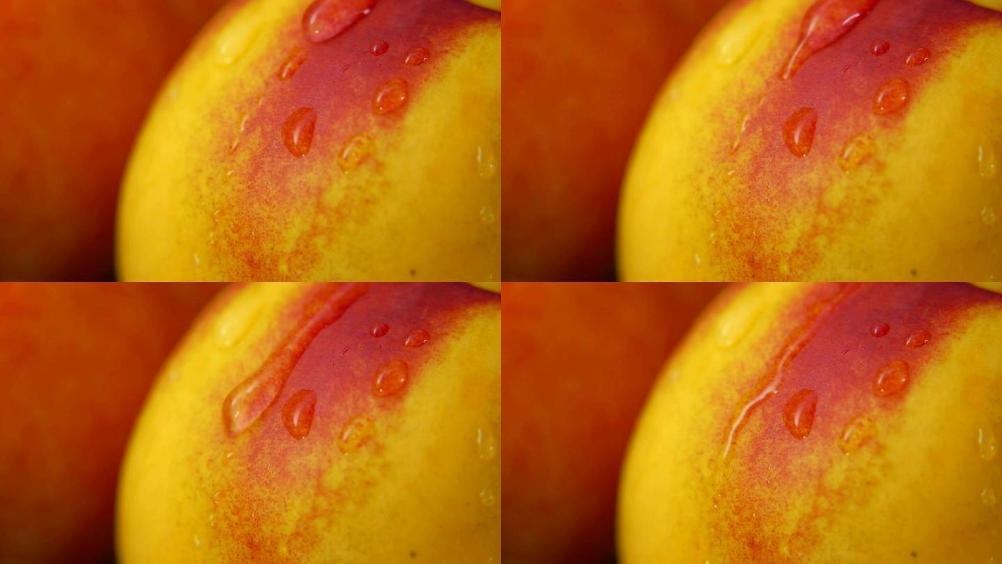 一滴水慢慢从油桃表面往下流的特写镜头