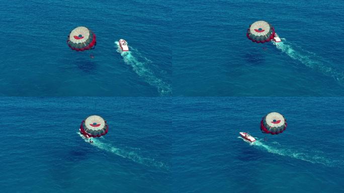 人们乘坐摩托艇拖曳降落伞飞行