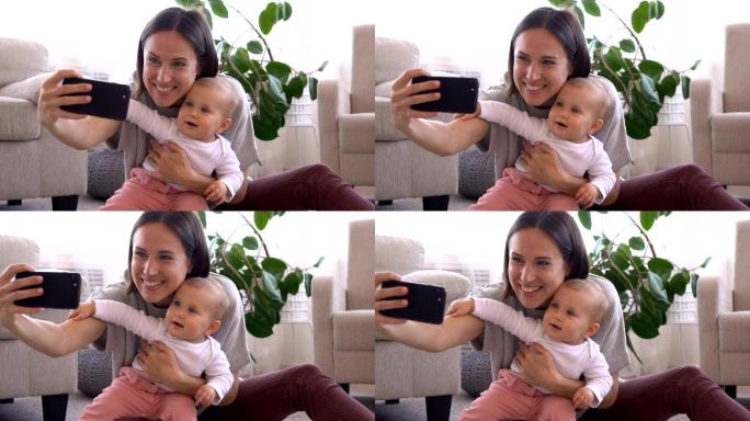 快乐的妈妈在家里用手机摄像头和女婴自拍