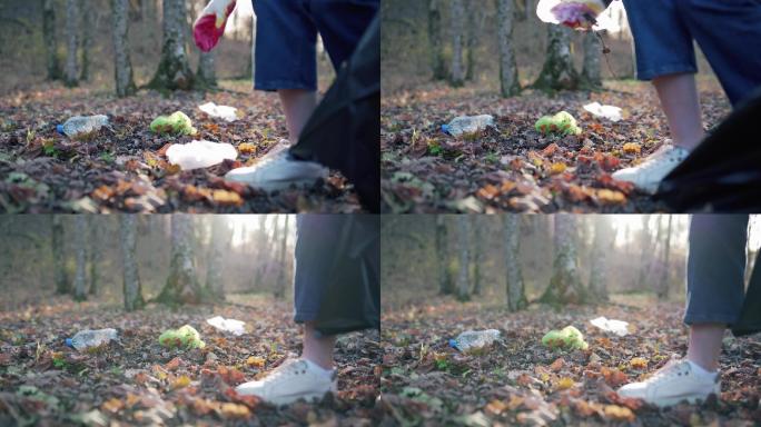 一个女人在落叶上收集脏垃圾