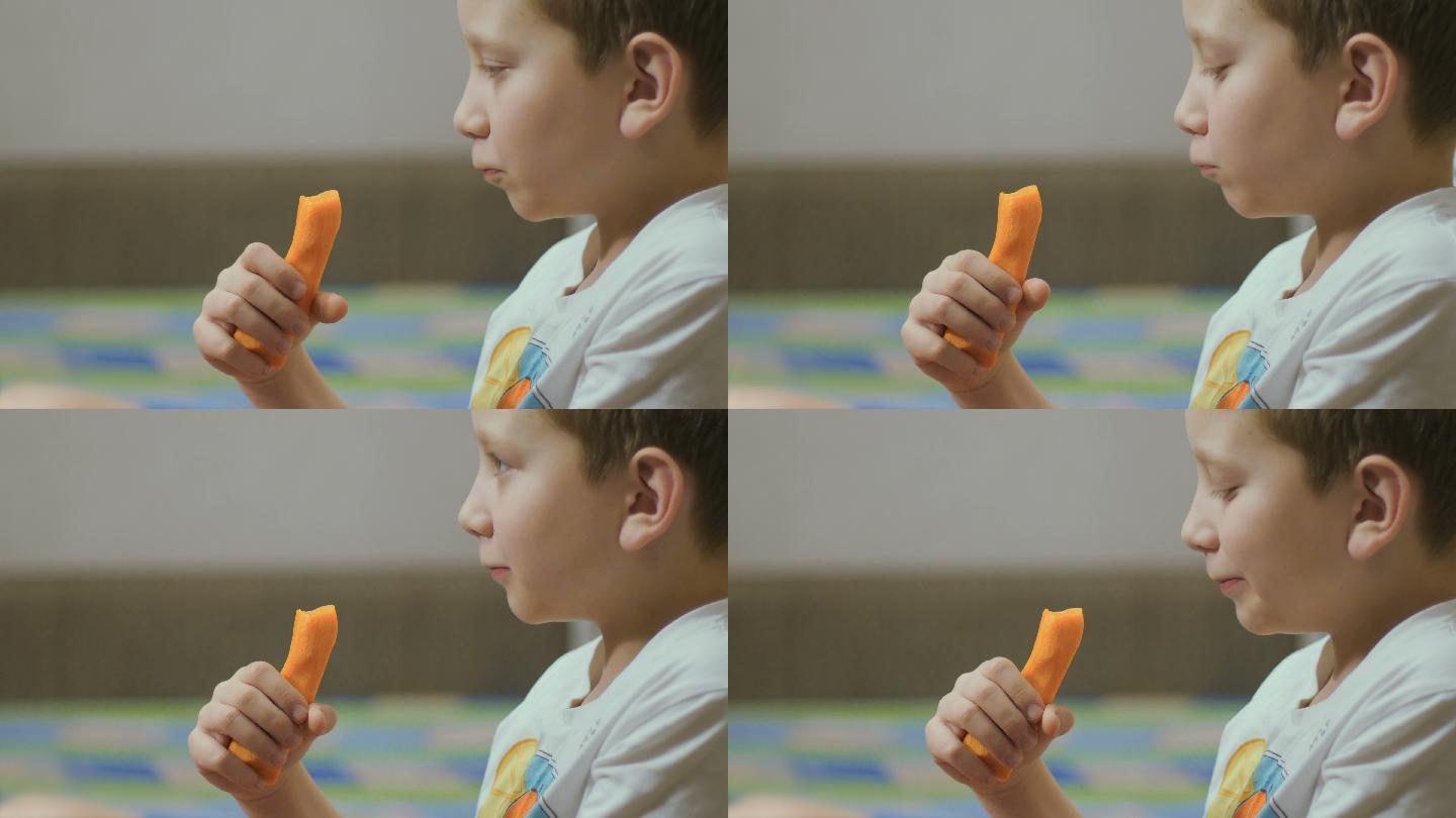 一个男孩在家吃胡萝卜