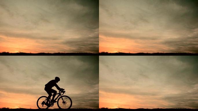 夕阳下的自行车手逆光背光人物剪影运动健身
