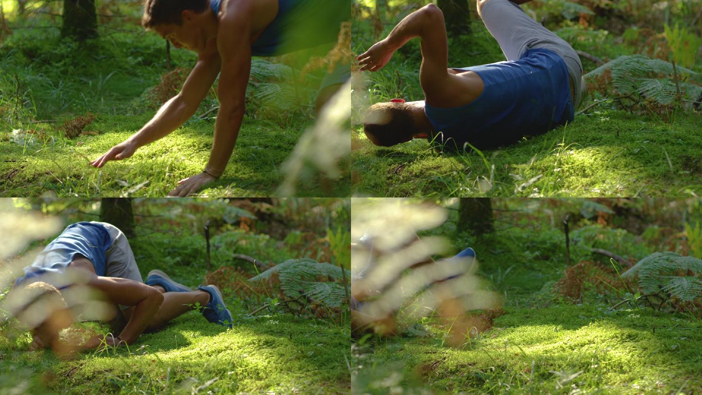 男性跑步者绊倒在柔软的苔藓地面上。