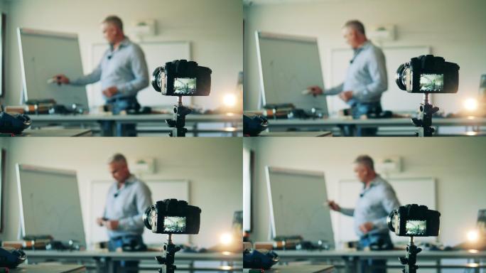 一名男子正在使用录像机拍摄他的课程