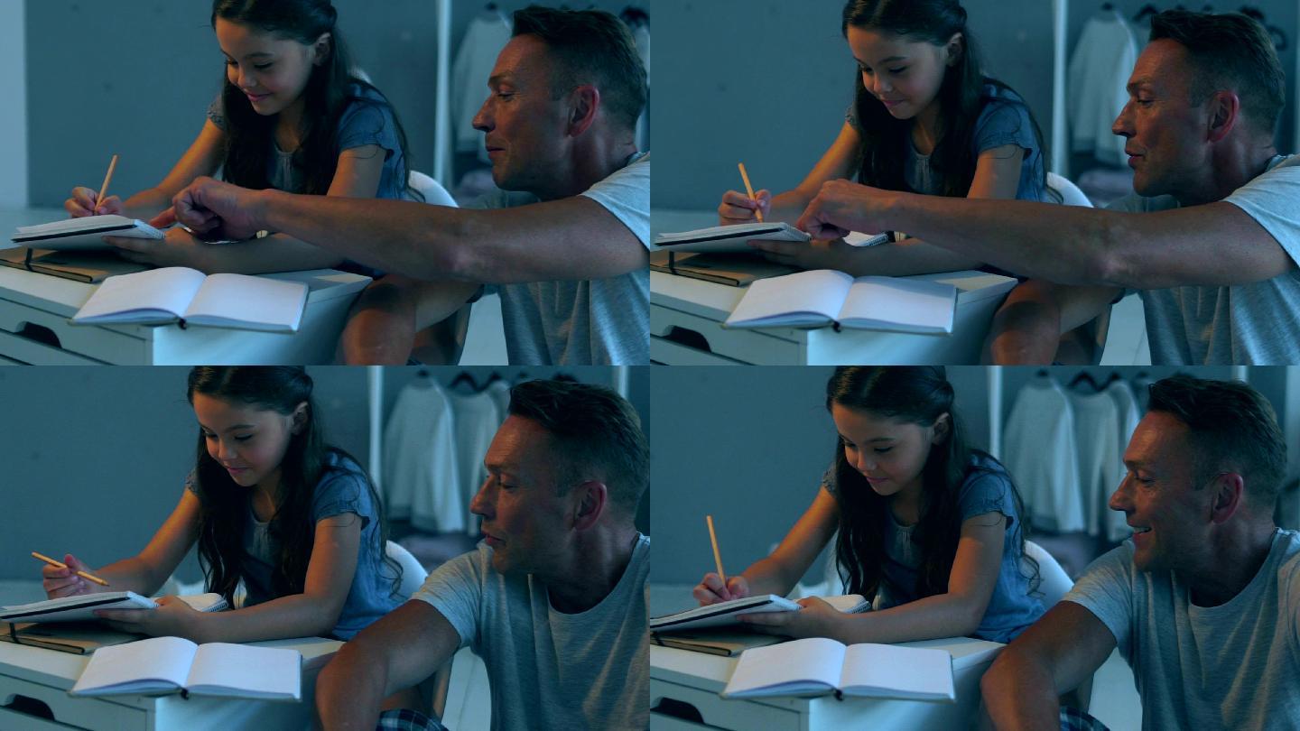 父亲帮助他的小女儿完成家庭作业