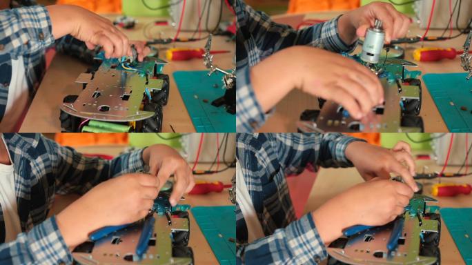 少年在修理车子玩具机械零配件电路