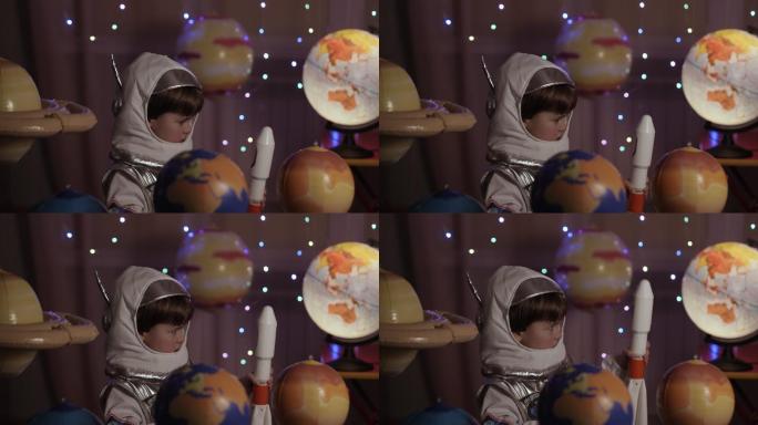 儿童梦想家玩着在行星间飞行的玩具