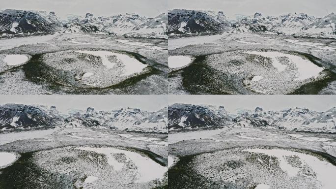 冬季以山脉冰川为背景的火山口鸟瞰图