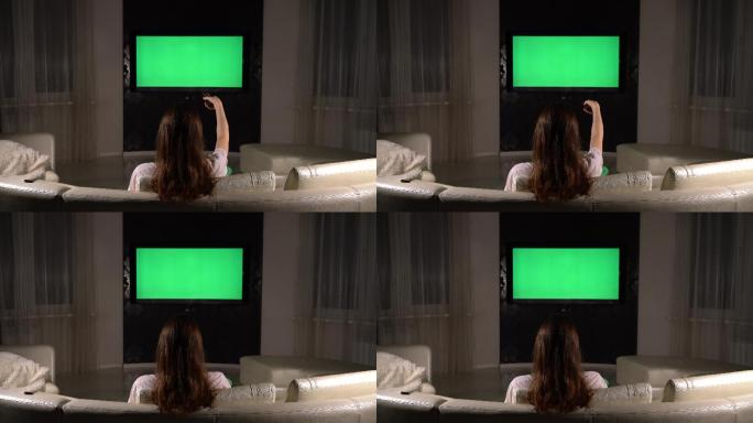 女孩在房间里看绿色屏幕的电视