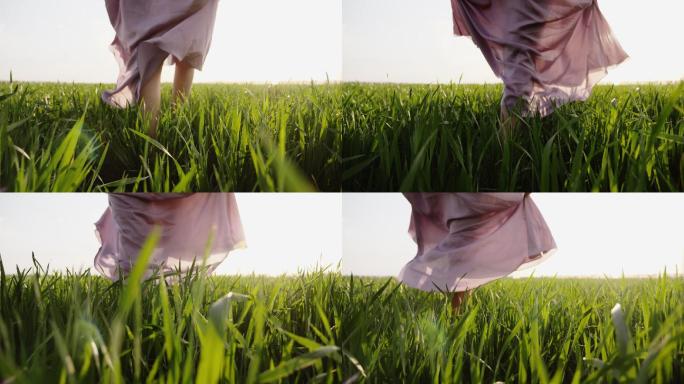 穿着粉色连衣裙的女人光着脚在草地上行走