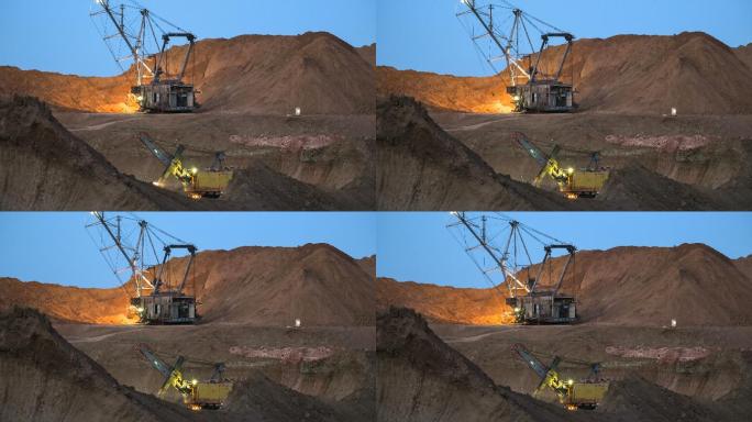 挖掘机将矿石装载到自卸卡车上