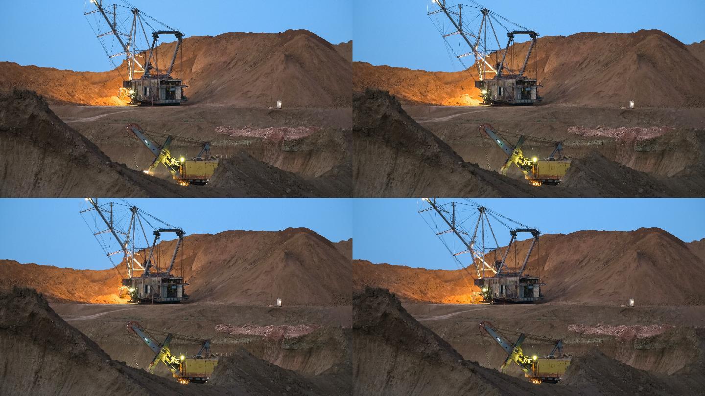 挖掘机将矿石装载到自卸卡车上