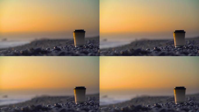 咖啡杯放在卵石海滩上