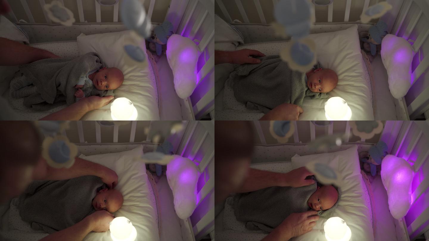 父亲把新生儿放在婴儿床上