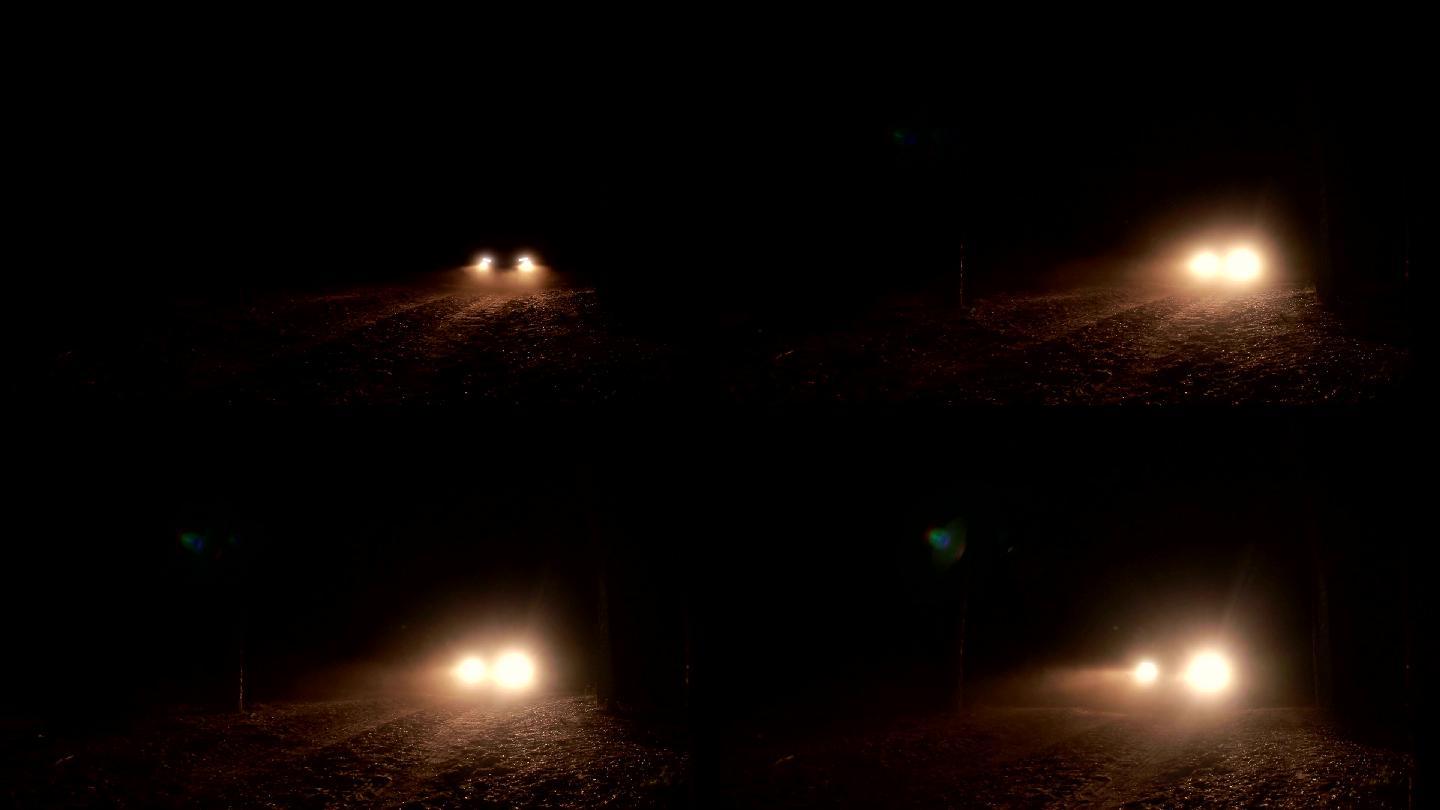 黑暗道路上驶近的汽车头灯