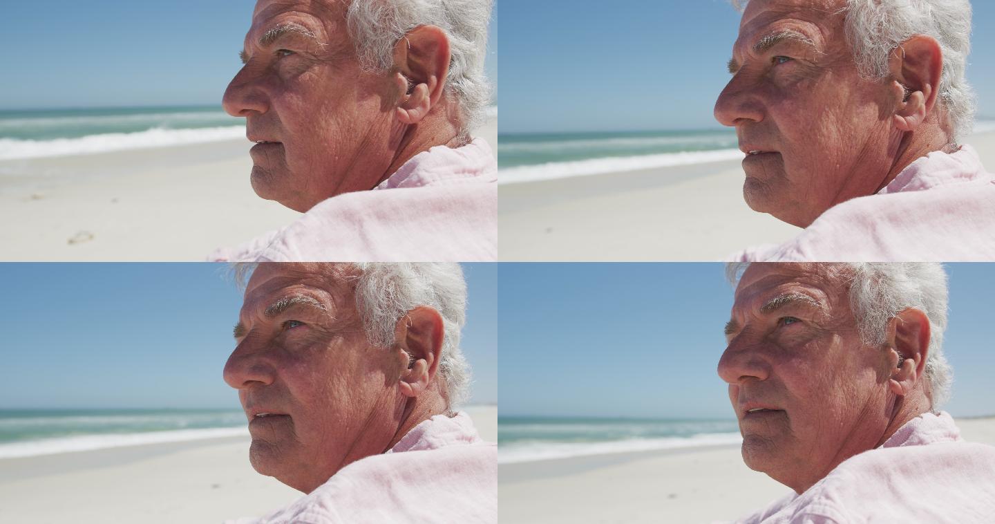体贴的高加索老人坐在海滩上