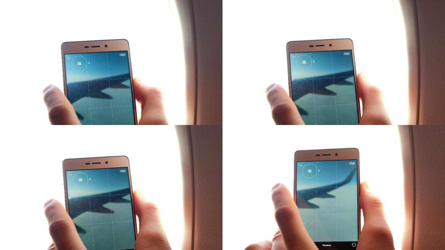 男子用手机拍下飞机窗外的景色