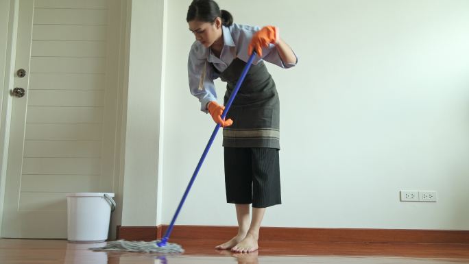 用拖把打扫房子的女人