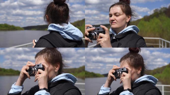 女摄影师在河岸上用老式胶卷相机拍照