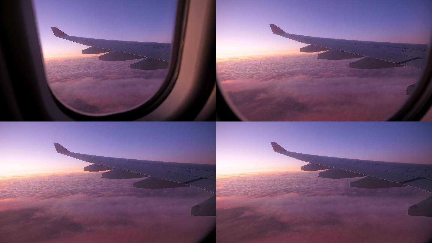 飞机的机翼在红色夕阳天空