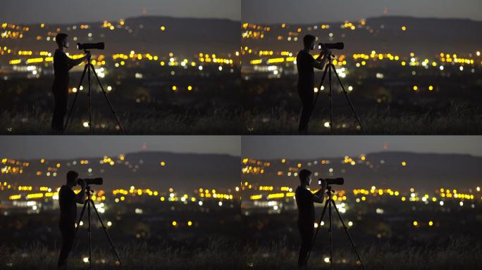 男子在夜市灯光的背景下用相机工作