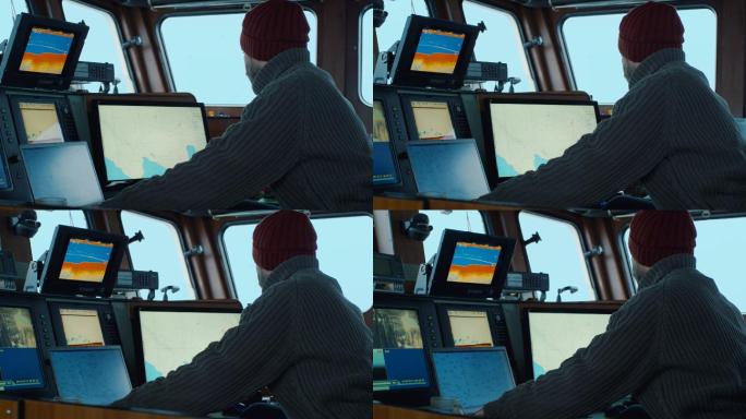商业渔船的船长，在他的船舱里处理海图。